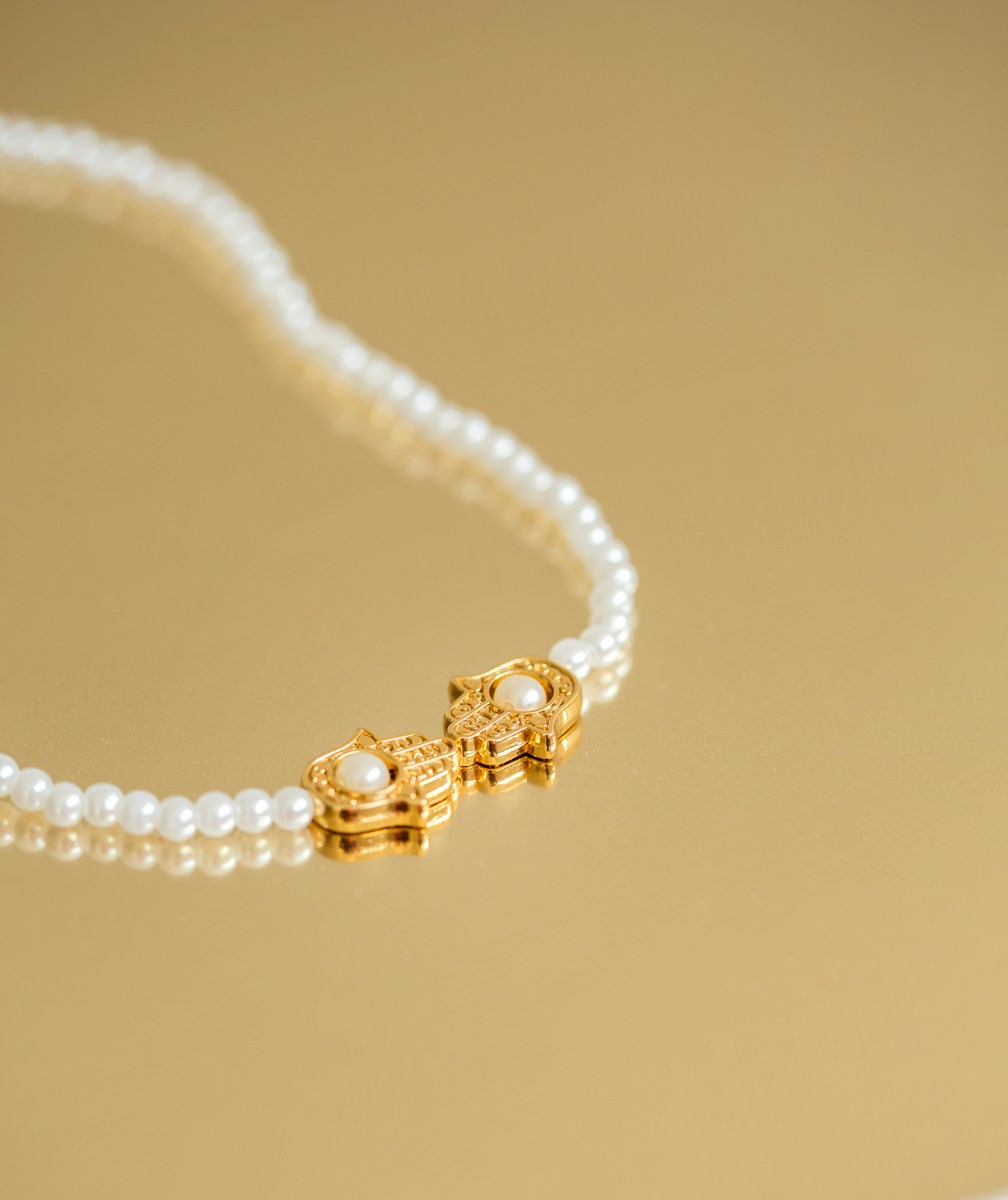 a necklace with pearls and a gold clasp